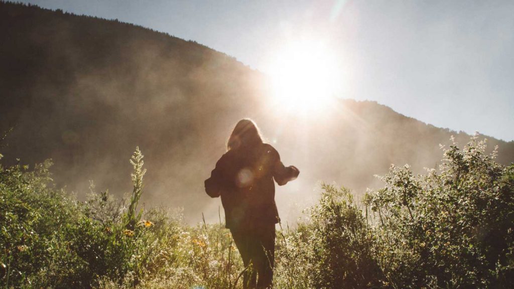 Woman walking in sunshine