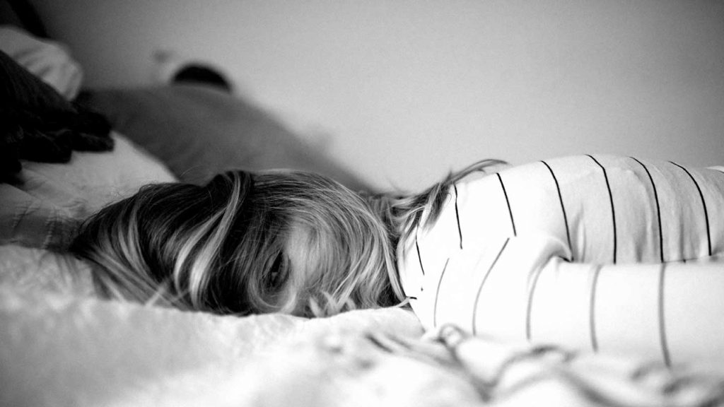 Girls looking sleepy on bed